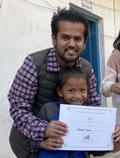 Kshitij awarding scholarship to a student
